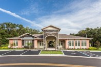 Freedom Gardens in Brooksville, Fla., was designed by Fugleberg Koch. The architectural design is based on a French country theme, with vertical accents, molded trim, and a color palette of stucco.