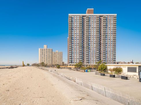 Residential amenities at Ocean Park Apartments include a large swimming pool; on-site parking; multiple playgrounds and outdoor spaces; a spacious community room; and more than 9,000 square feet of commercial space occupied by a physical therapy center, a pharmacy, a grocer, and quick-service retail.